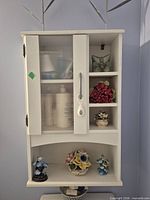 Front view showing door, open cubbies and bottom shelf