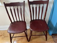 Front view showing both antique arrow-back chairs