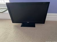 Front view of RCA LED TV on stand