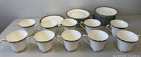 Full set showing ten teacups, ten saucers, eleven side plates, one soup plate