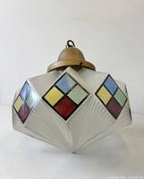 Full view of hanging light showing enamelled squares and metal cap