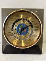 Straight-on view of Sextant world time clock showing full dial and case