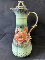 Full view of chocolate pot front showing hand-painted poppy design and gilded handle