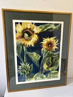 Frontal view of framed sunflower painting showing full composition, mat and frame