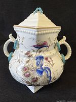 Front view showing hand-painted bird, floral design and handles