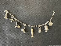Full view of bracelet laid flat showing all eight charms