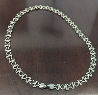 Full view of sterling chain link necklace in oval form