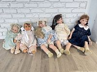 All five dolls lined up for size and style comparison