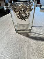 Front view showing full bucket and metal emblem