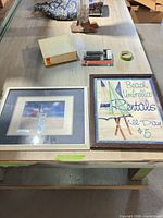 Overall view of both framed wall art pieces on table