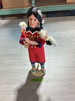 Front view of Danbury Mint Native American doll on stand
