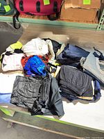 Pile of assorted golf outerwear on table