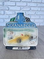 Front of ceramic Indianapolis 500 decanter showing race car image and date
