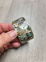Full view of bracelet showing abalone shell and mother-of-pearl flower