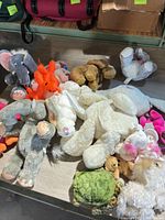 Group view of assorted plush toys on table