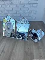 Group shot of three vintage mirrored dresser frames