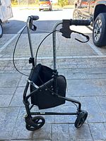 Side view of tri-wheel walker showing frame, wheels, brakes and pouch