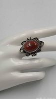 front view of carnelian silver ring on display hand