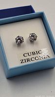 front view of cubic zirconia stud earrings in box