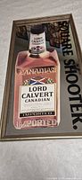 Full view of framed Lord Calvert Canadian bar mirror showing bottle graphic and text