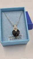 Pendant necklace in original box showing heart crystal and rhinestone bail