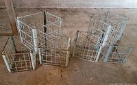 Six vintage metal milk crates standing on floor