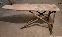 Side view of wooden folding ironing board set up