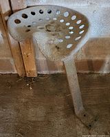 Top view of perforated cast iron tractor seat