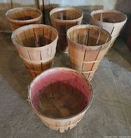 Six wooden peach baskets front view