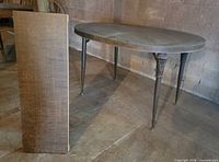 Full view of table with leaf positioned upright beside it