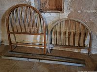 Headboard and footboard with side rails leaning against wall