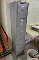 Full view of tall gray five-door metal locker