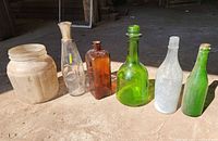 Six glass containers lined up