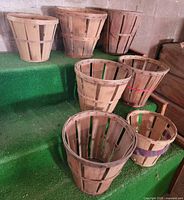 Seven wood peach baskets front view