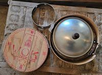 Wooden box lid, support ring, wok with lid stacked