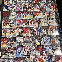 Wide layout view showing majority of the 106 hockey cards arranged in rows, highlighting variety of teams and insert finishes