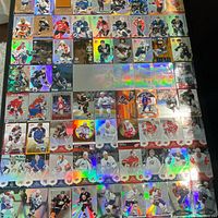 Overall view of numerous foil hockey cards laid out in rows
