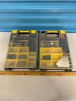 Two plastic organizer cases with assorted hardware displayed closed