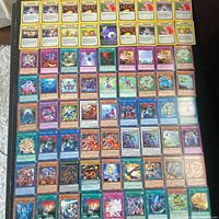 Overhead view showing full lot arranged in rows; variety of Yu-Gi-Oh! and Pokémon cards visible