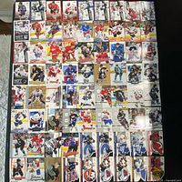 All 86 cards laid out in rows showing fronts, including die-cut logo cards