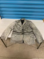Full view of blazer laid flat on table