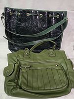 Front view of both handbags showing tote behind and satchel in front