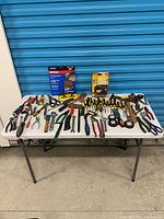 Full view of table with entire assortment of tools and packaged items