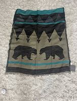 Full view of scarf laid flat showing bear and geometric pattern