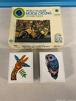 Front view of jigsaw puzzle box and two wooden puzzle boxes