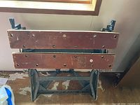 Front view of Black & Decker Workmate workbench folded upright showing wood jaws and metal frame