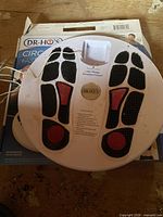 Top view of circular foot therapy platform resting on box