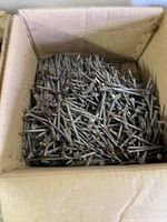 Cardboard box filled with assorted nails