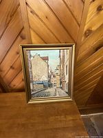 Gold-framed European street scene painting