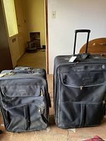 Two Samsonite black suitcases front view